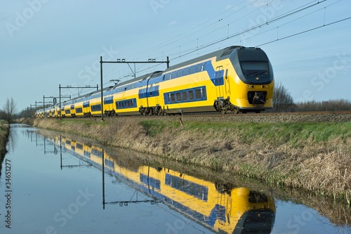 Photo: Dutch train en route along canal Dutch train en route along canal