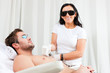 Man in cosmetic salon receiving waxing Man in cosmetic salon receiving waxing