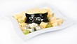 several kinds of cheese with grapes and sauce