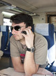 An Adult Man with Smartphone using Wireless Network on Train