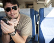 An Adult Man with Smartphone using Wireless Network on Train