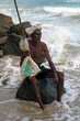 The old man from sri lanka sits on the shore of the ocean