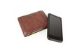 Foto: A wallet with a modern cellphone. A wallet with a modern cellphone.