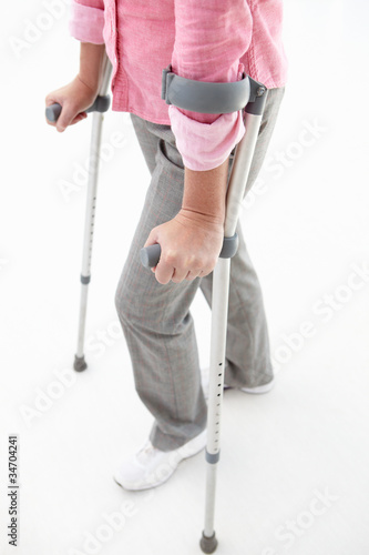 Photo: Woman walking with crutches Woman walking with crutches