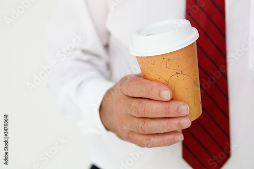 Photo: Businessman holding takeout coffee Businessman holding takeout coffee