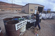 Woman recycles glass bottles.