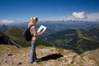 Woman tourist in mountain look at the map