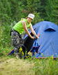 female hiker in front of camp female hiker in front of camp