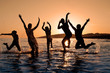 Silhouette of family jumping