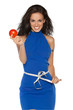 Pretty smiling woman in blue dress measuring waist