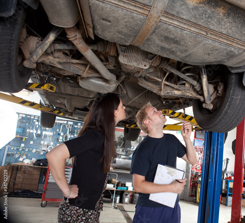 Photo: Mechanic Showing Customer Repairs Mechanic Showing Customer Repairs