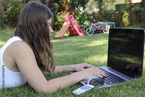 Photo: teenage girl with wireless laptop outdoor teenage girl with wireless laptop outdoor