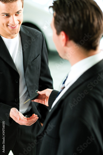 Photo: man buying car - key being given man buying car - key being given