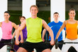 Fitness group with barbell in gym