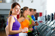 Photo: People in gym on treadmill running People in gym on treadmill running
