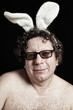 Foto: Cute man in glasses with white bunny ears Cute man in glasses with white bunny ears