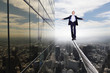 Business man balancing on the rope