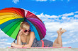 Photo: glamorous girl in retro style by color umbrella on the beach glamorous girl in retro style by color umbrella on the beach