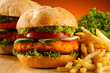 Big hamburger, French fries and vegetables Big hamburger, French fries and vegetables
