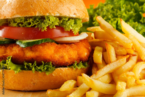 Photo: Big hamburger, French fries and vegetables Big hamburger, French fries and vegetables