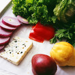 Slices of onions, tomatoes, cheese and fruit
