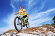 Foto: A young male riding a mountain bike A young male riding a mountain bike