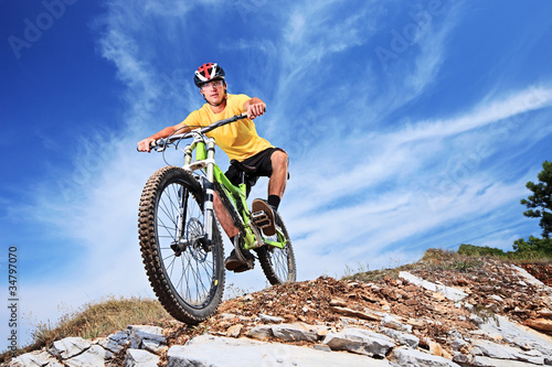 Photo: A young male riding a mountain bike A young male riding a mountain bike