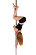 Photo: Young woman exercising pole dance fitness Young woman exercising pole dance fitness