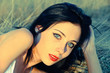 Photo: Portrait at the sunset: beautiful young girl lying on grass. Cro Portrait at the sunset: beautiful young girl lying on grass. Cro