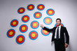 Businessman showing a wall of targets
