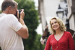 A middle-aged man taking a photograph of his partner