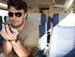 An Adult Man with Smartphone using Wireless Network on Train