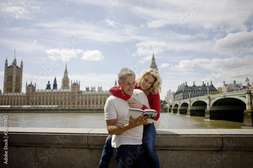 Photo: A middle-aged couple in front of the Houses of Parliament A middle-aged couple in front of the Houses of Parliament