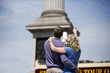Photo: A middle-aged couple standing in front of Nelson's column A middle-aged couple standing in front of Nelson's column