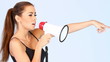 Beautiful woman is screaming loudly by megaphone
