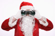 Santa claus looking through binoculars