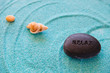 Stones and shell on a blue sand