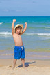 child in the beach in a playful and happy atitude child in the beach in a playful and happy atitude