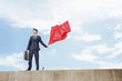 Businessman holding a red flag