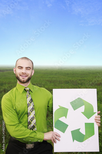 Photo: Businessman holding a recycle sign Businessman holding a recycle sign