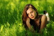 brunette lying on green grass
