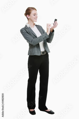 Photo: Businesswoman using electronic organizer Businesswoman using electronic organizer