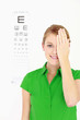 Businesswoman covering one eye with her hand
