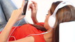 Young girl on couch listen to the music with headphones