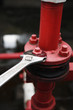 Spanner tightening bolt on a pipe