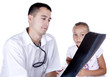 The doctor looks a? x-ray picture