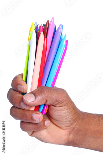 Photo: hand with Color Crayons on white hand with Color Crayons on white