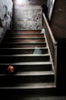 Old abandoned stairs with broken glass and a ball