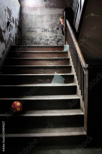 Photo: Stairwell littered with broken glass a ball and a child Stairwell littered with broken glass a ball and a child