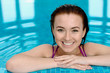 Smiling young girl in a swimming pool